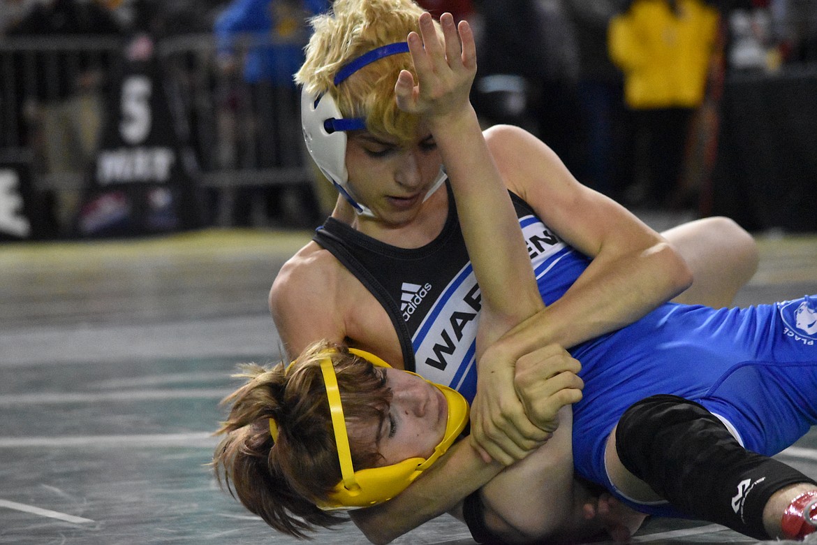 Freshman Michael Gonzalez of Warden High School holds his opponent in a headlock during the WIAA Mat Classic XXXIII state tournament on Feb. 18 at the Tacoma Dome.