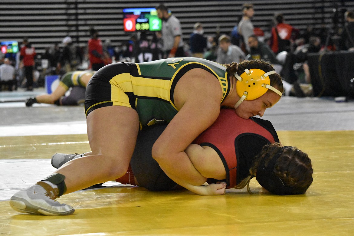 Quincy High School senior Shannon Workinger works to pin a Mount Baker wrestler on Feb. 18 at the WIAA Mat Classic XXXIII state tournament at the Tacoma Dome. Workinger took first place in the girls 170-pound weight class.