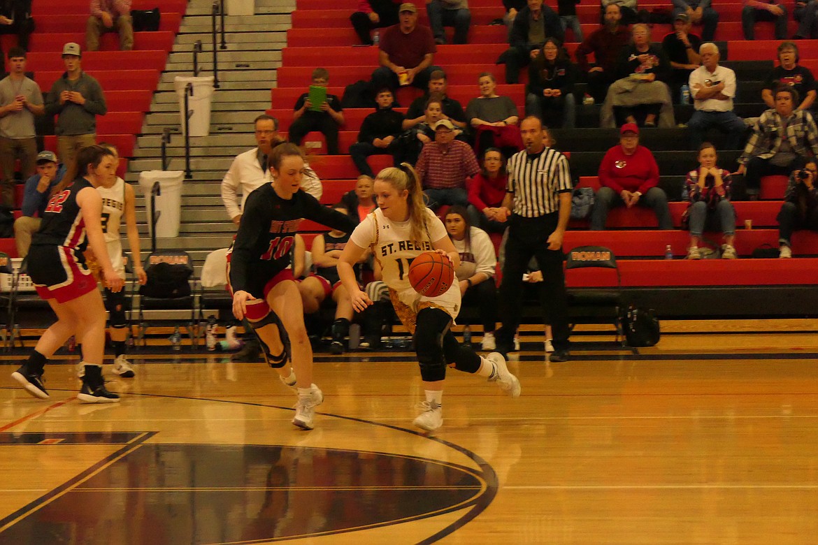 Carroll College bound Katelyn Christensen guards St. Regis's senior Baylee Pruitt during the recent District tournament.  Pruitt is bound for Providence College in Great Falls.   (Chuck Bandel/VP-MI)