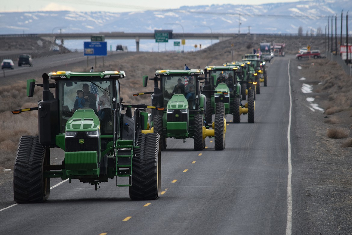 A convoy of tractors arriving for the Freedom Ride and Rally near the interchange of I-90 and Dodson Road on Saturday.