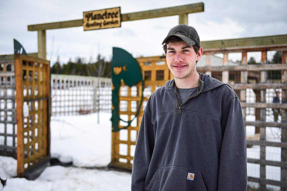 Colton Henriksson outside the Planetree Garden at Logan Health Whitefish, where he and fellow Boy Scouts from Troop 1901 were building greenhouses on top of the garden boxes to extend the growing season of the garden. (Casey Kreider/Daily Inter Lake)