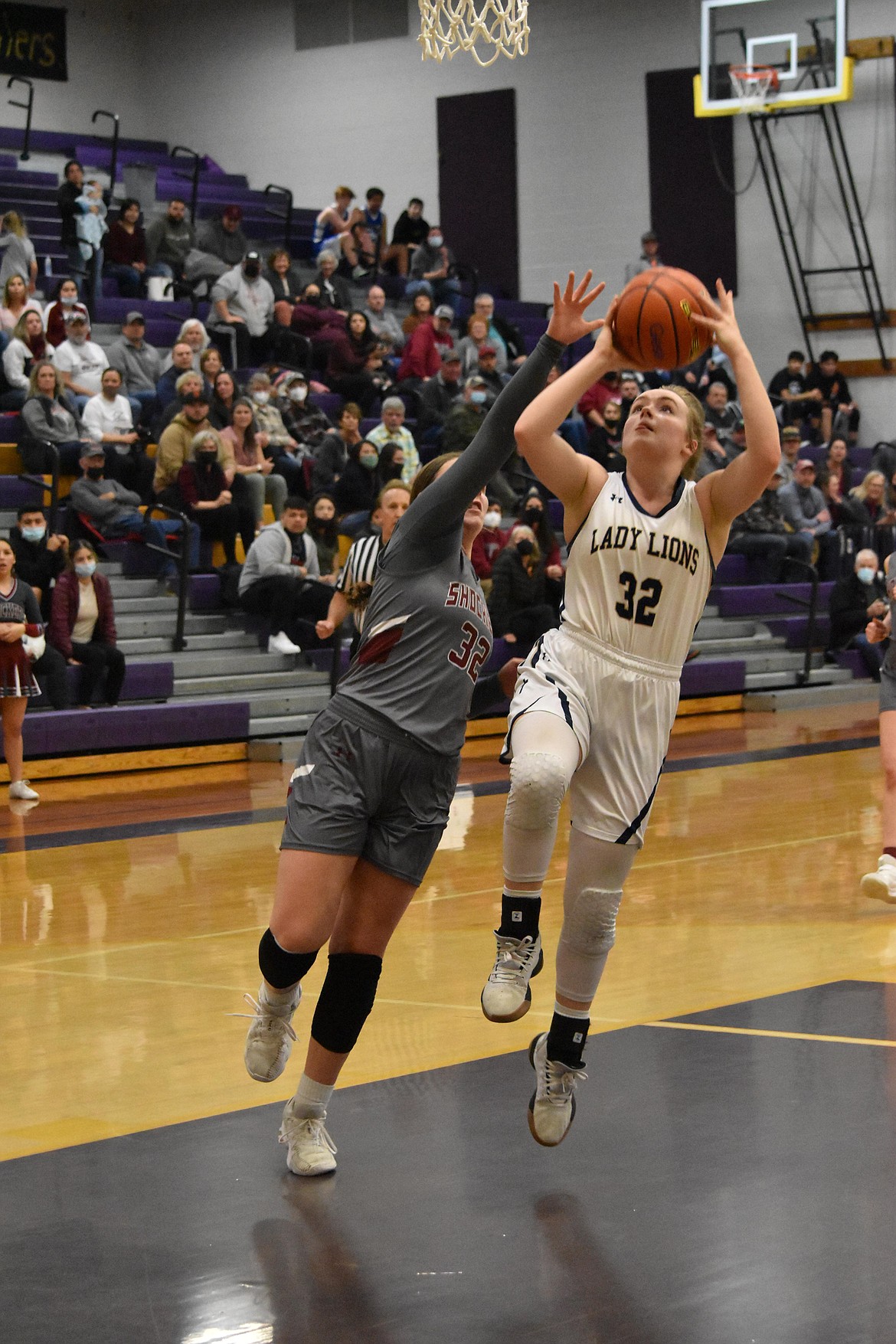 MLCA/CCS junior McKenna Meise attempts a layup as a Waterville-Mansfield player puts her hand up to block it on Feb. 17.