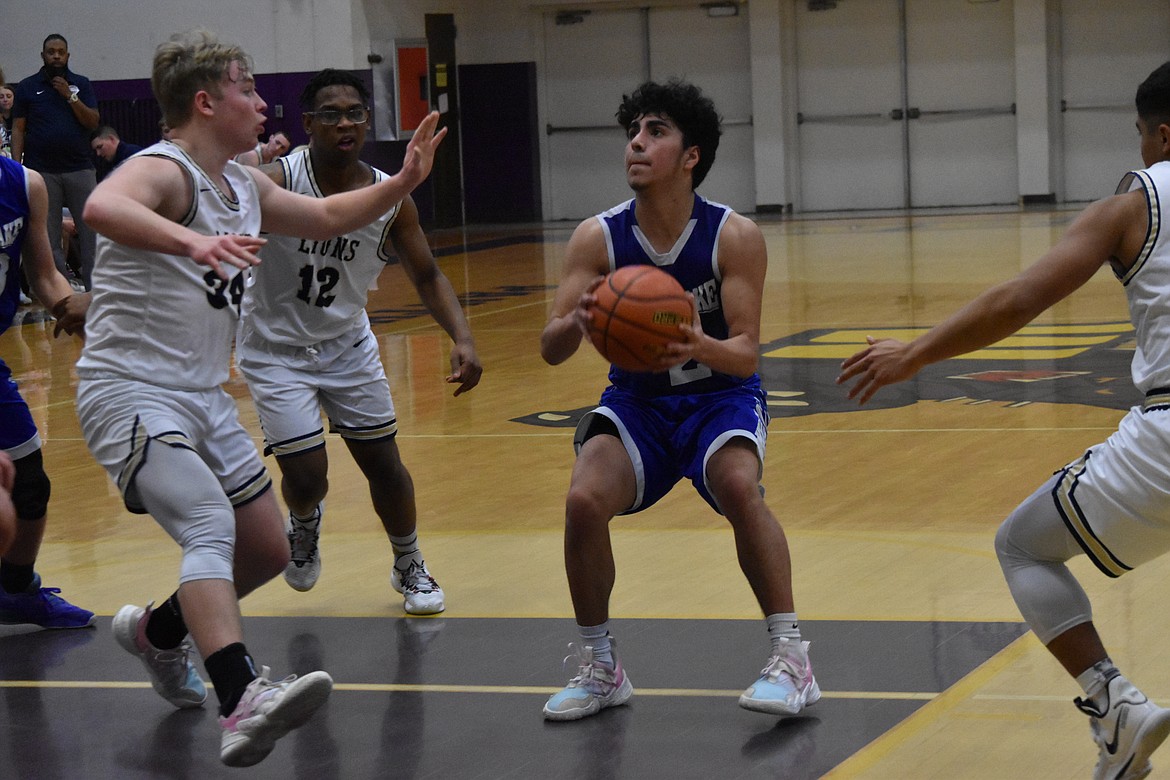 Soap Lake High School senior Diego Garza (2) starts to shoot a basket during the district championship game on Feb. 17 against MLCA/CCS.