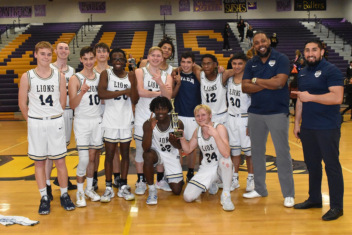 The MLCA/CCS boys basketball team poses with its district title trophy on Feb. 17 after beating Soap Lake High School.