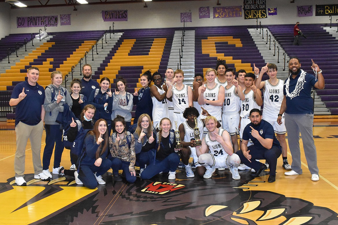 The MLCA/CCS girls and boys basketball teams pose together with their district title trophies Feb. 17.