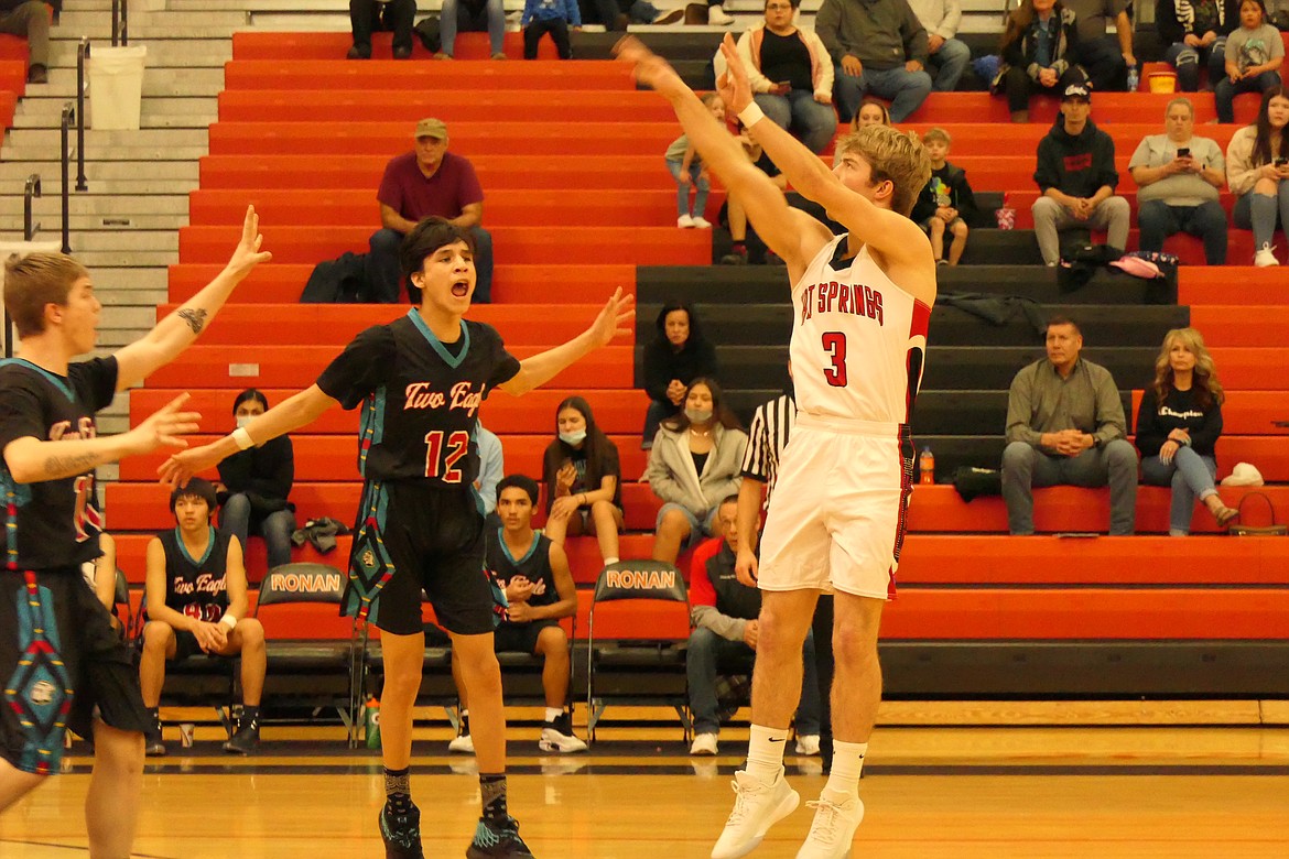 Hot Springs senior Jack McAllister shoots over Two Eagle River's Cal Burke (12) during their consolation final Saturday evening in Ronan.  (Chuck Bandel/MI-VP)