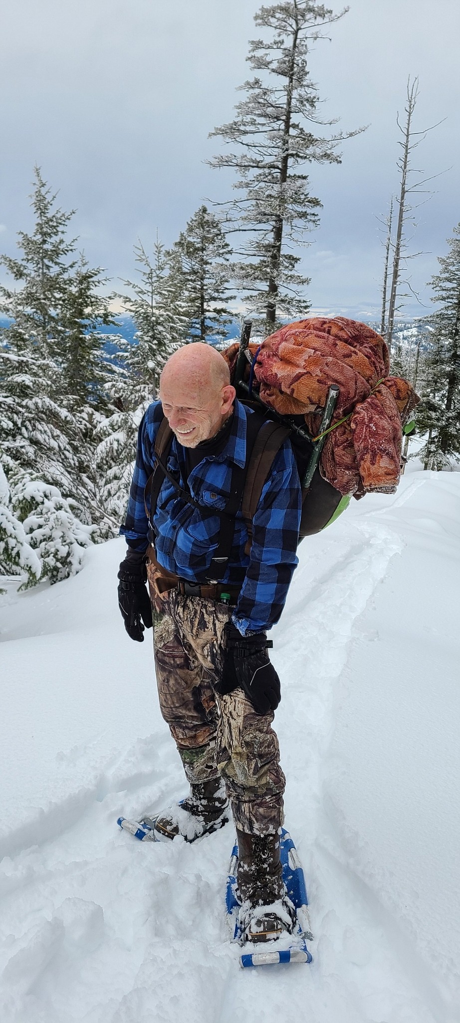 Pat Flanigan, 79, stops for a quick break during the 4.5-mile snowshoe hike to Joe Avery's cabin.
