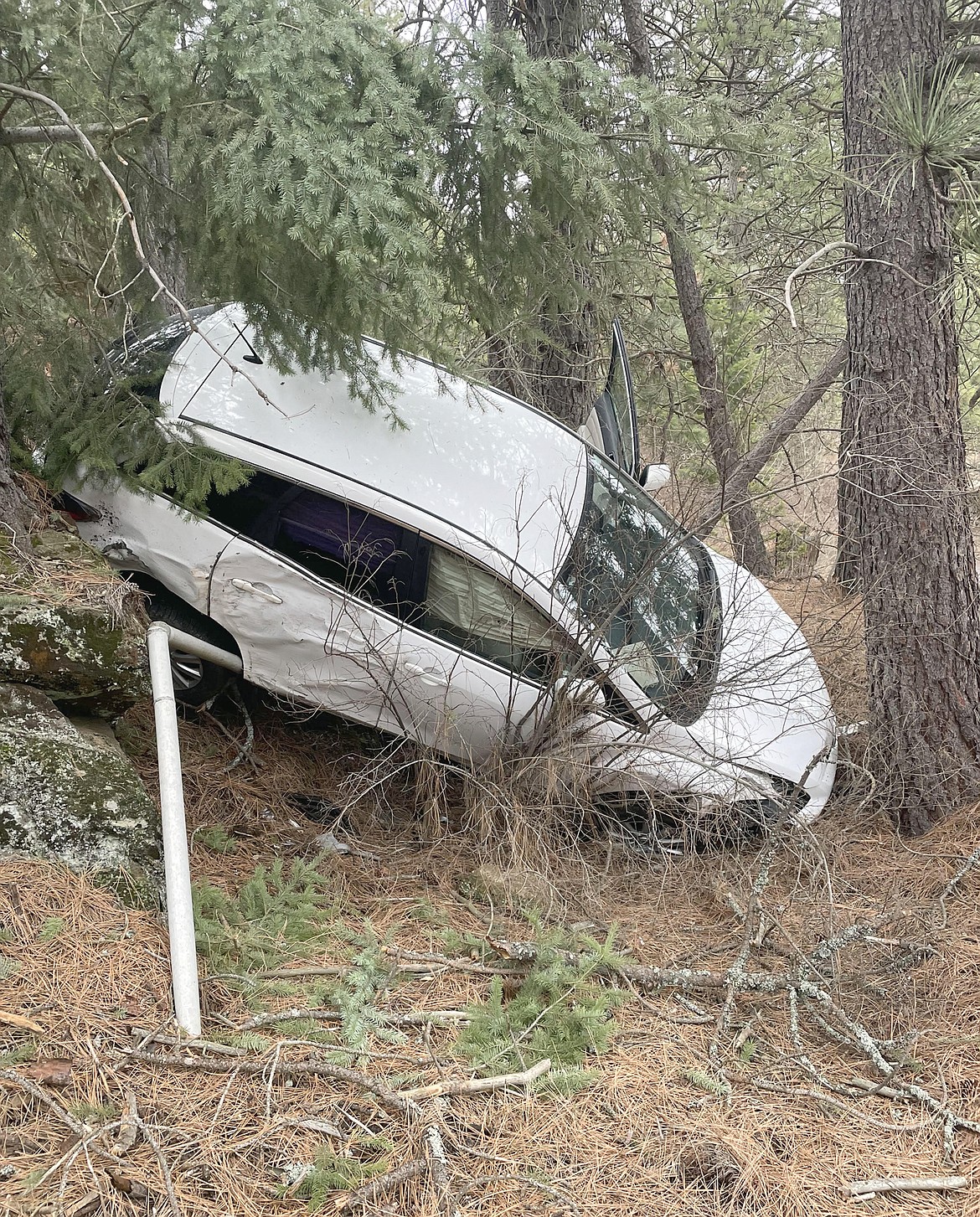 Photo courtesy Jessica Ponce Ashlee Schilling's Mazda rests down an embankment after crashing off Cougar Gulch Road Saturday afternoon.