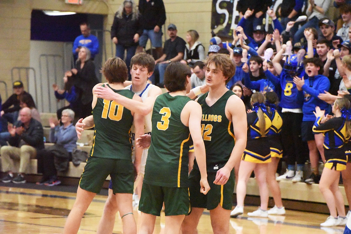 Whitefish players congratulate each other and Libby players on a good season after a divisional play-in game on Friday. (Derrick Perkins/The Western News)