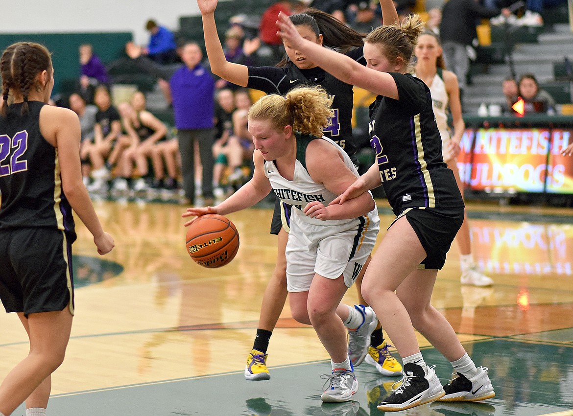 Bulldog Ainsley Scott breaks through the Polson defense during a play-in game on Friday at WHS. (Whitney England/Whitefish Pilot)