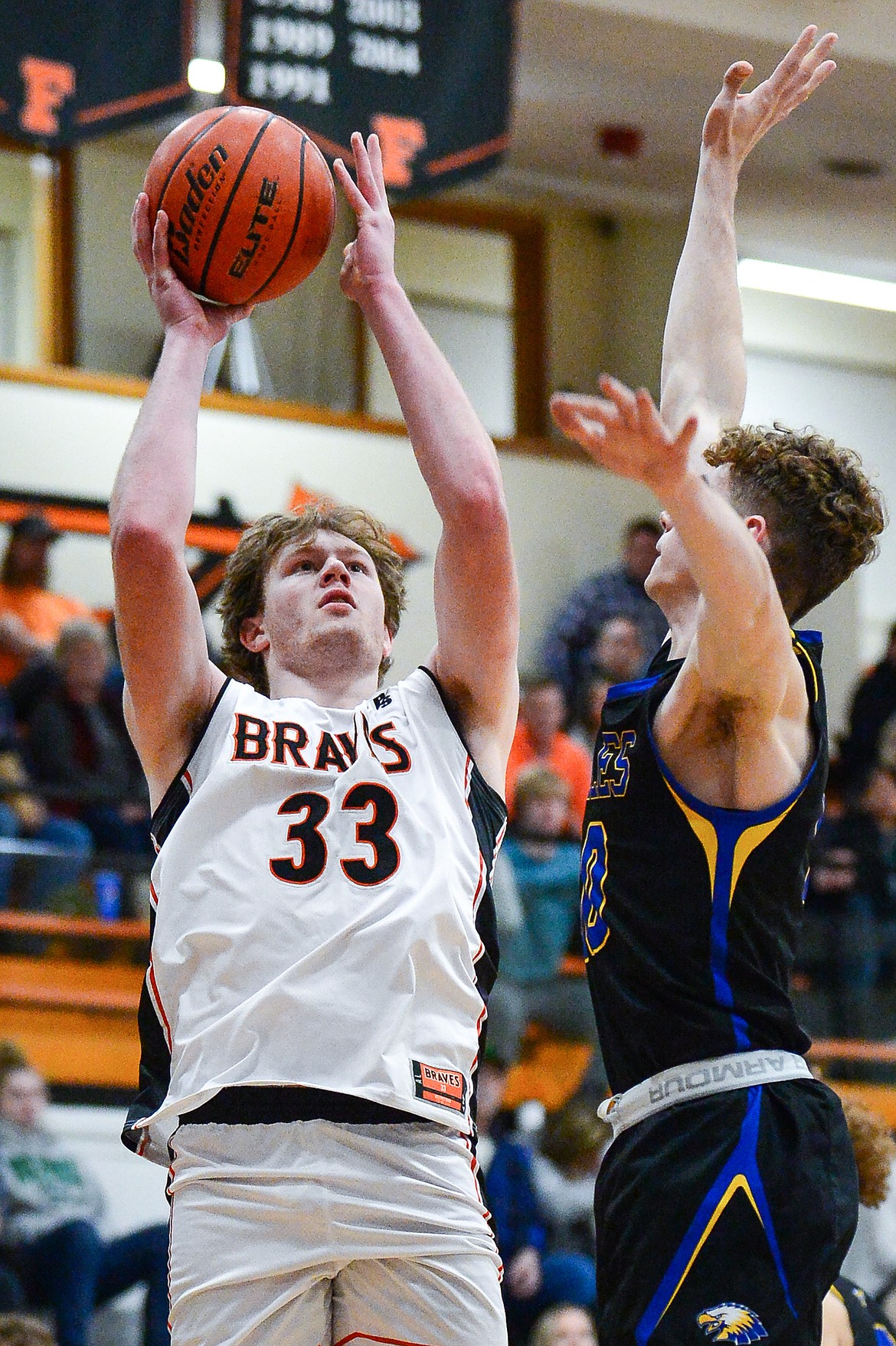 Flathead's Joe Hansen (33) goes to the basket against Missoula Big Sky's Caden Bateman (10) at Flathead High School on Tuesday, Feb. 22. (Casey Kreider/Daily Inter Lake)