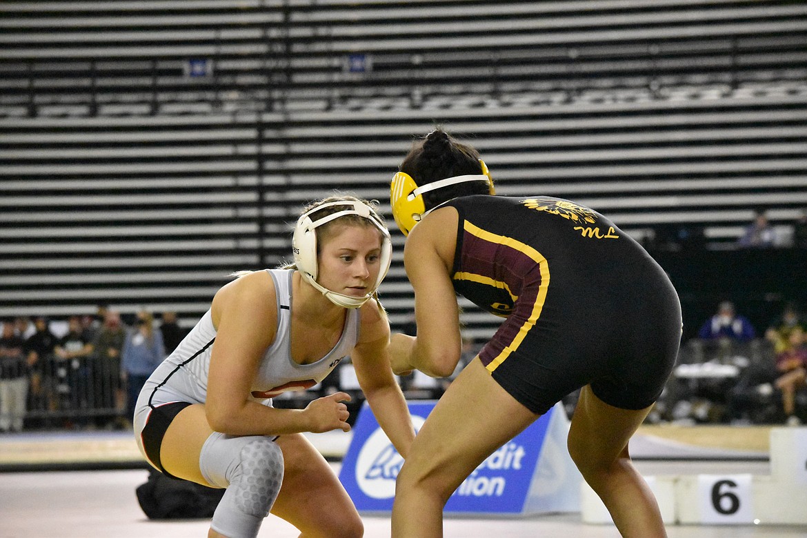 Othello wrestler Lexi Monday (left) eyes her opponent, Ashley Dayana Naranjo of Moses Lake, in the state championship match at Mat Classic XXXIII on Feb. 19. Monday finished second in the 115-pound class.