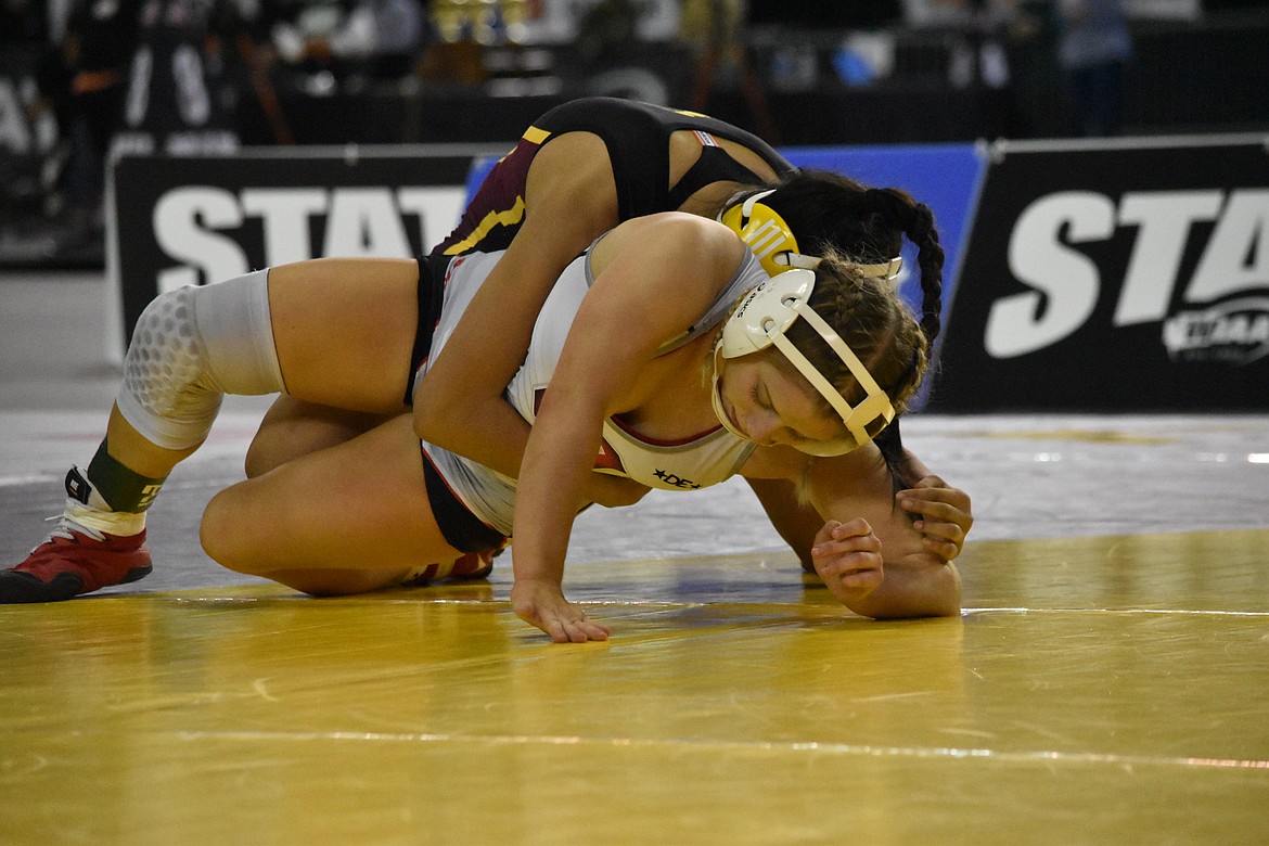 Othello wrestler Lexi Monday (in white) tries to escape the hold of Ashley Dayana Naranjo of Moses Lake during the state championship match in the 115-pound class at Mat Classic 2022 on Feb. 19.