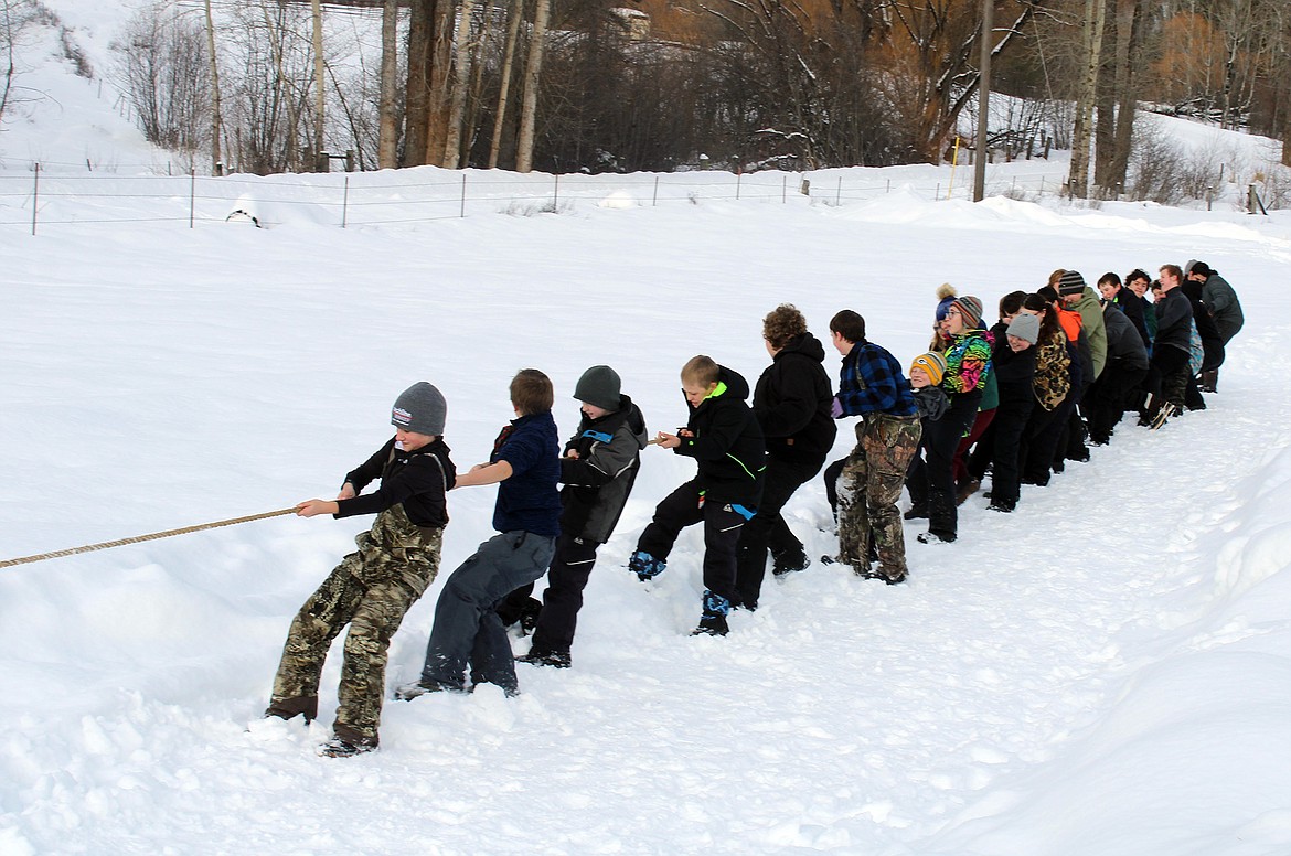 Members of the Northwest District of the Montana Council, Boy Scouts of America, recently hosted the annual Klondike Derby Winter Camporee near Coram. Area scout troops participated in a weekend-long event that tested their outdoor survival skills. Pictured above are troop members participating in the tug-of-war competition. (Courtesy photo)