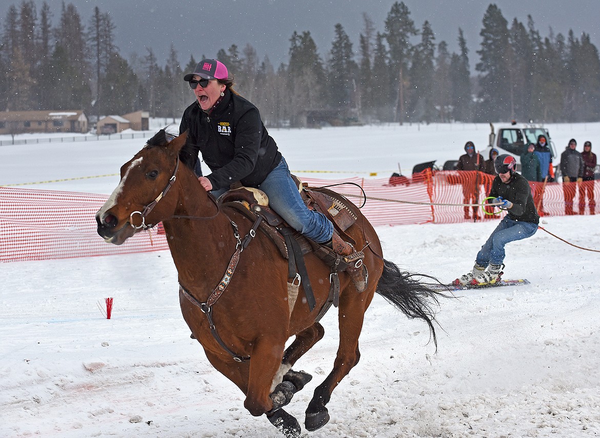 A rider yells out to her horse as they pull a skier through the course at the Whitefish Ski Joring event on Sunday. (Whitney England/Whitefish Pilot)