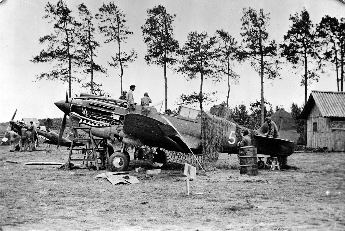 Flying Tigers P-40 fighter under repair in China in World War II.