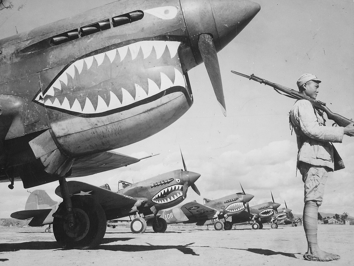 Chinese soldier guarding Flying Tigers P-49 fighters (c.1942).