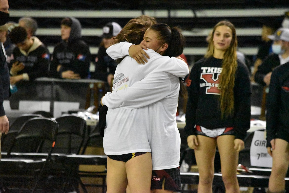 Moses Lake High School sophomore Ashley Dayana Naranjo, right, and junior Bianca Johnson, left, hug after both became state champions in their respective weight classes.