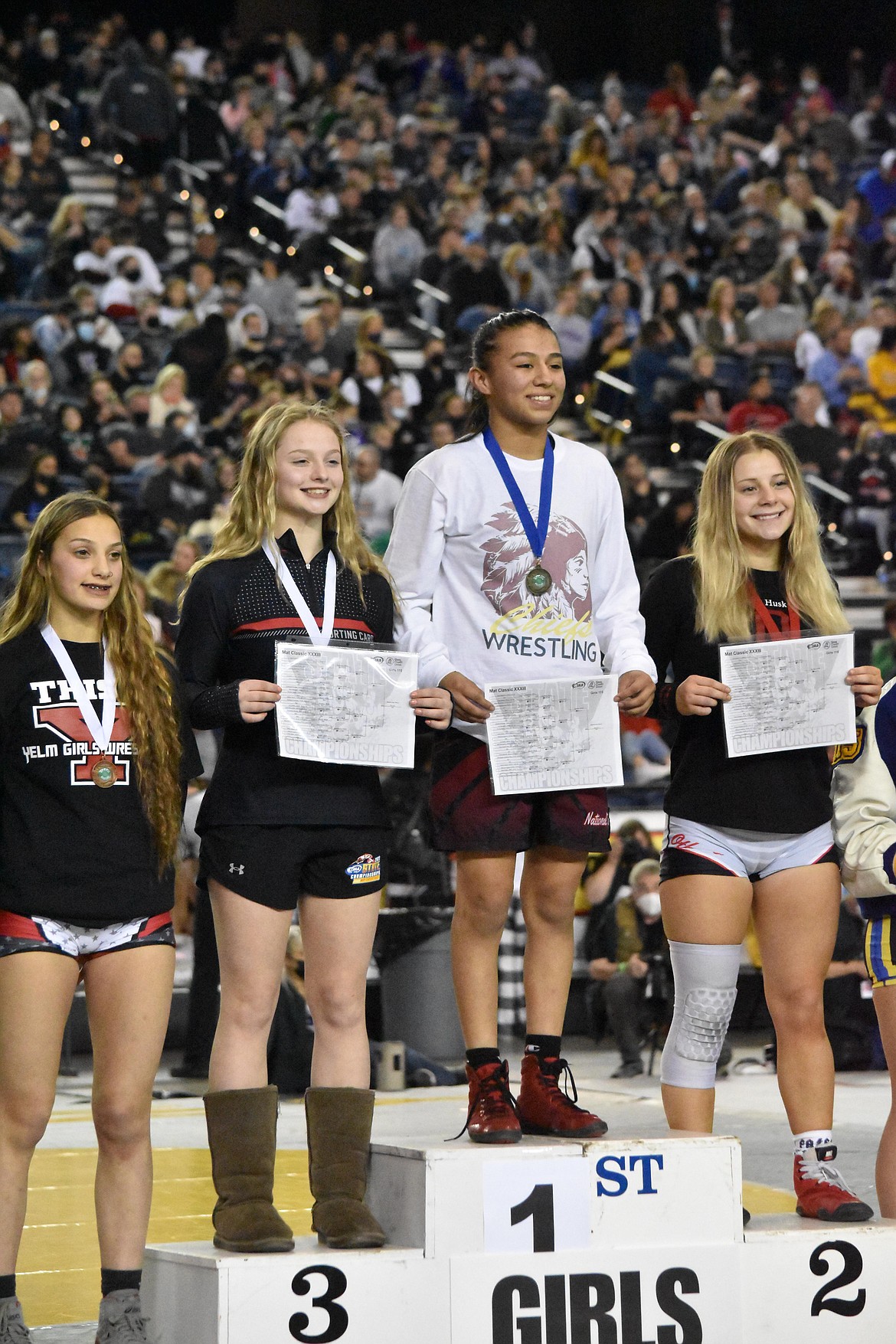 Moses Lake High School sophomore Ashley Dayana Naranjo poses on the podium after winning the championship match to take the state title for the girls 115 pound weight class.