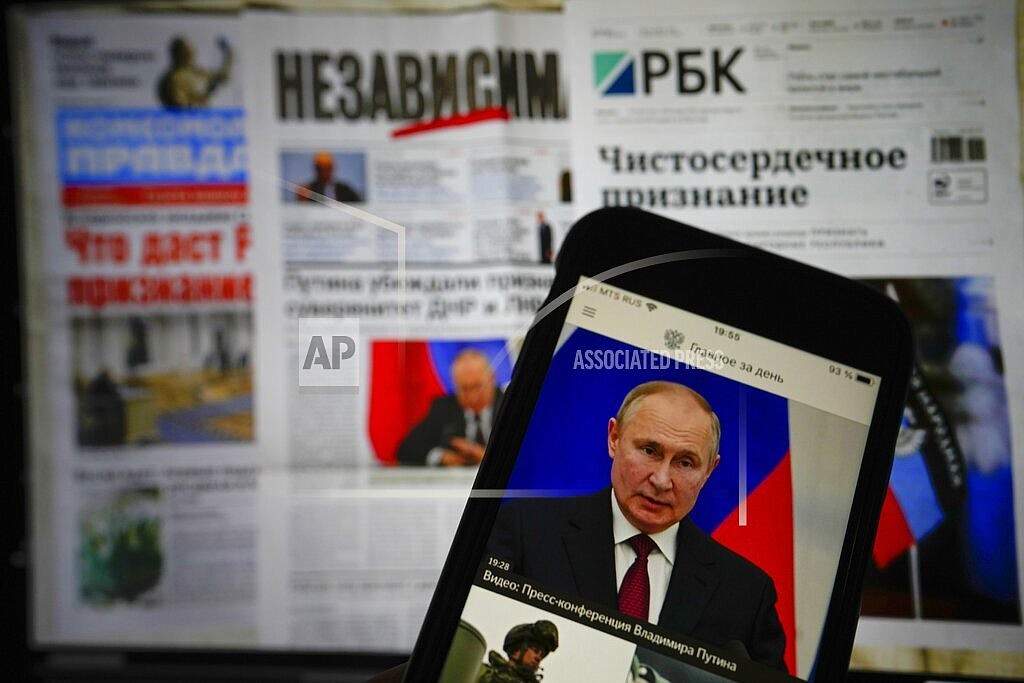 The app of the Russian government newspaper is displayed on an iPhone screen showing Russian President Vladimir Putin during his speech in the Kremlin in Moscow, Russia, Tuesday, Feb. 22, 2022. As the West sounds the alarm about the Kremlin ordering troops into eastern Ukraine and decries an invasion, Russian state media paints a completely different picture. It portrays the move as Moscow coming to the rescue of war-torn areas tormented by Ukraine’s aggression and bringing them much-needed peace. (AP Photo/Alexander Zemlianichenko Jr)