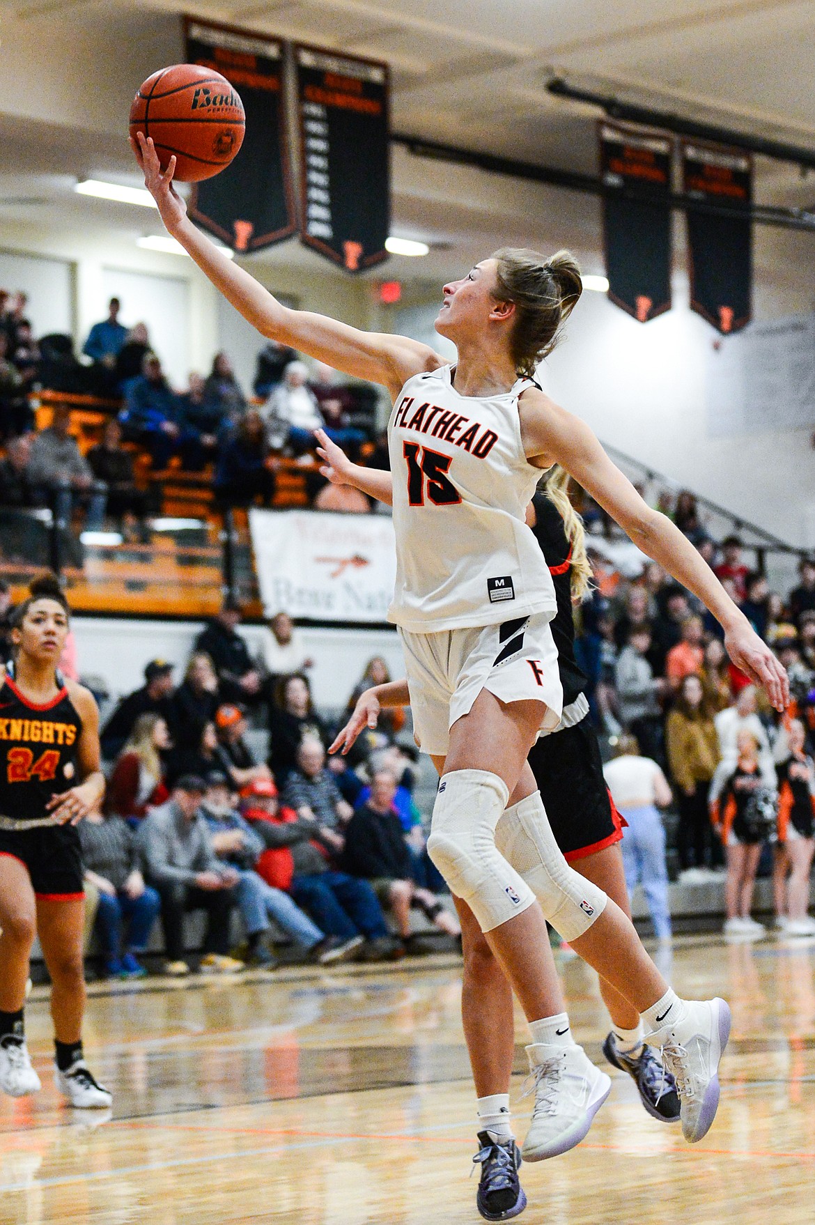 Flathead's Clare Converse (15) drives to the basket against Missoula Hellgate at Flathead High School on Thursday, Feb. 24. (Casey Kreider/Daily Inter Lake)