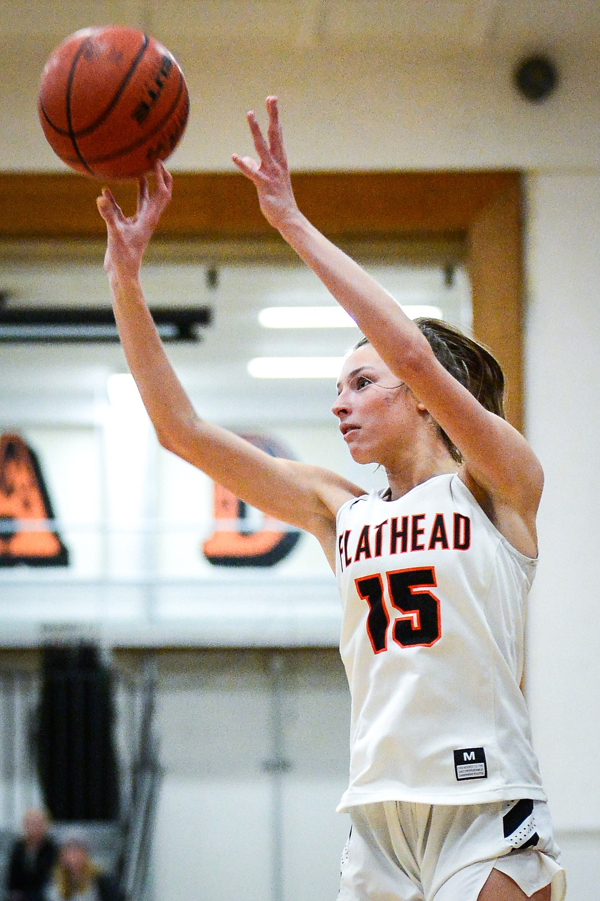 Flathead's Clare Converse (15) banks in a three against Missoula Hellgate at Flathead High School on Thursday, Feb. 24. (Casey Kreider/Daily Inter Lake)