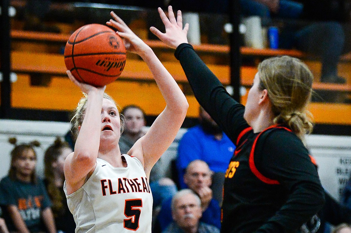 Flathead's Maddy Moy (5) shoots a three guarded by Missoula Hellgate's Bailee Sayler (22) at Flathead High School on Thursday, Feb. 24. (Casey Kreider/Daily Inter Lake)