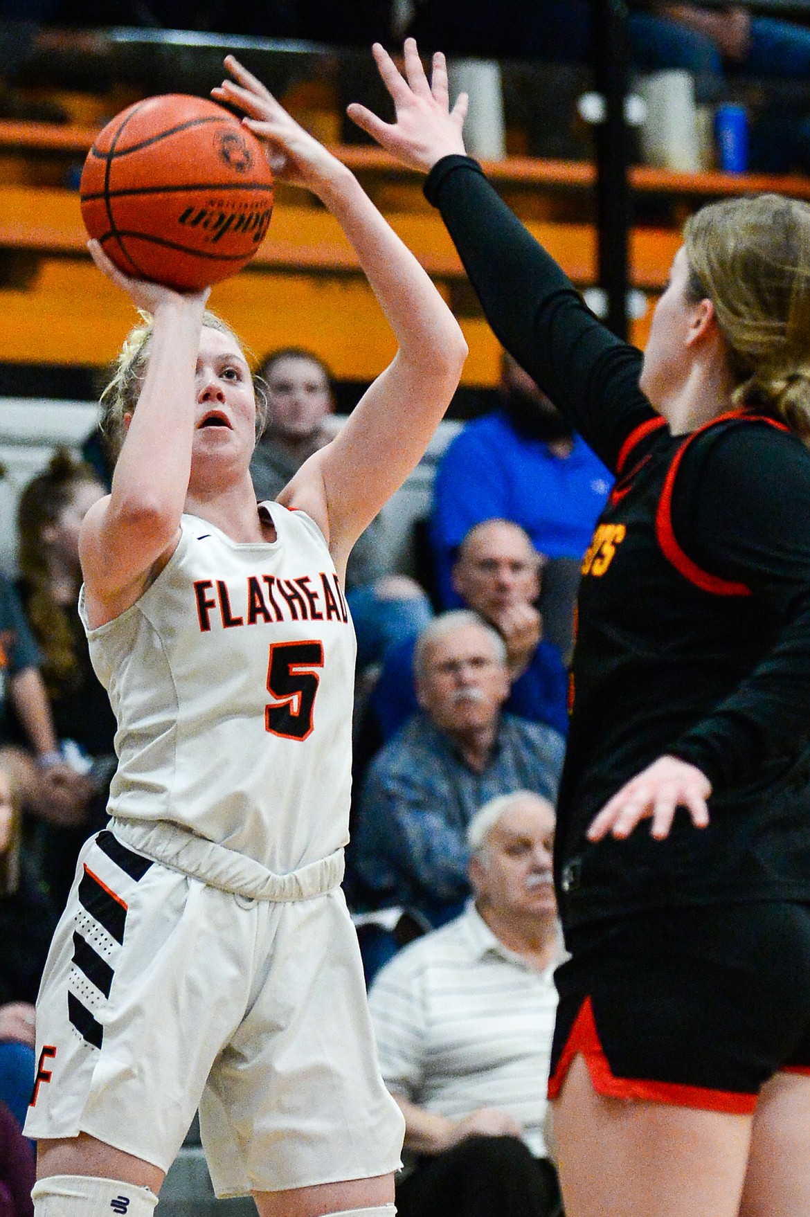 Flathead's Maddy Moy (5) shoots a three guarded by Missoula Hellgate's Bailee Sayler (22) at Flathead High School on Thursday, Feb. 24. (Casey Kreider/Daily Inter Lake)