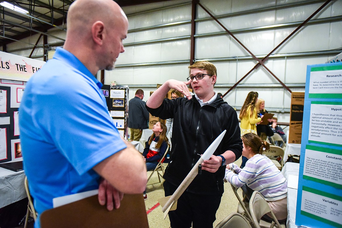 Josh Lee, a student at Evergreen Junior High, discusses his project with judge Marshall Fladager at the Flathead County Science Fair on Thursday, Feb. 24. Lee's project titled "Fins -- It's a Numbers Game" dealt with the optimal number of stabilization fins on homemade rockets. (Casey Kreider/Daily Inter Lake)