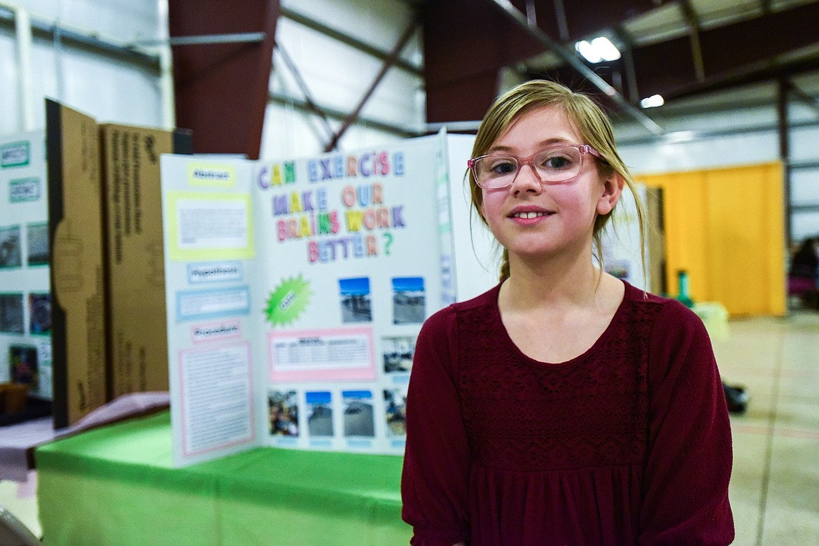Avery Lacy, a fourth-grader at Edgerton Elementary, poses with her project titled "Can Exercise Make Our Brains Work Better" at the Flathead County Science Fair on Thursday, Feb. 24. (Casey Kreider/Daily Inter Lake)