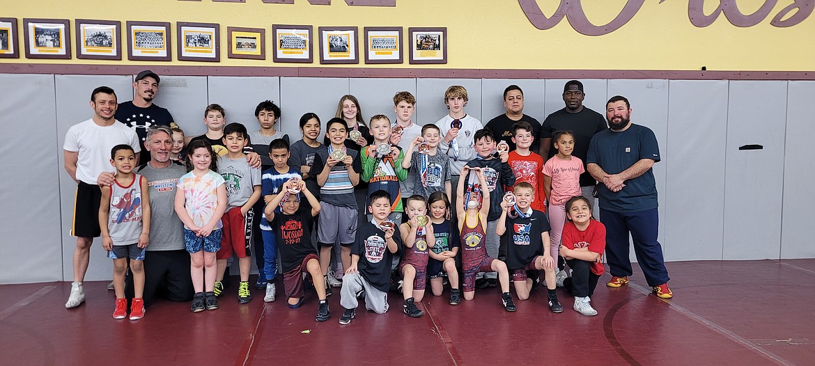 Moses Lake Wrestling Club members and coaches pose with their medals after participating in the Washington State Wrestling Association Folkstyle Championship at the Tacoma Dome on Feb. 20.