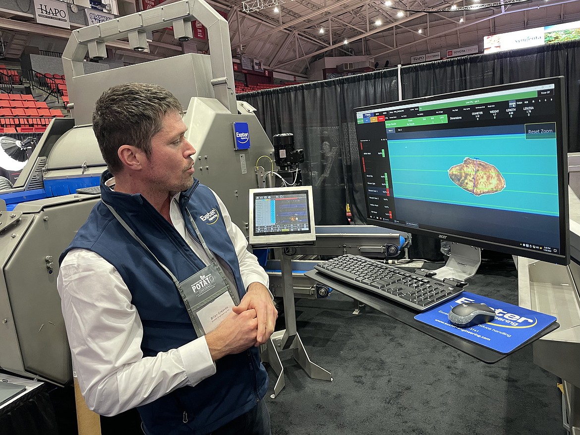 Brian Greaves demonstrates how Exeter Engineering’s AI images and analyzes potatoes for damage and defects at the Washington Oregon Potato Conference in Kennewick in late January.