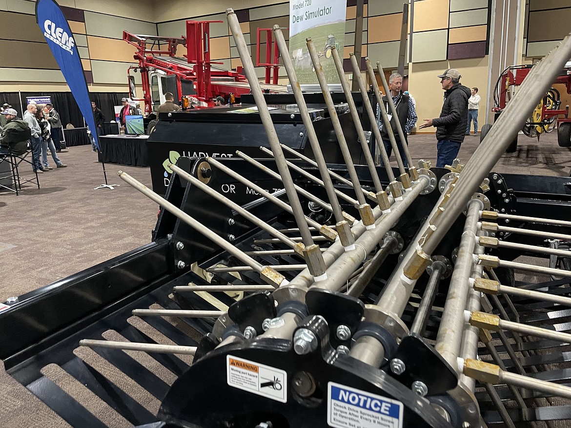 A close-up of the tines that deliver high-press, high temperature water into windrows of drying hay in order to simulate dewfall prior to baling.