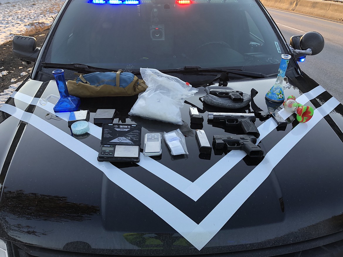 Numerous items seized by Idaho State Police are displayed on the hood of a patrol car following a traffic stop Thursday. Among the many items include 350 "Mexi-blue" fentanyl pills, over a pound of methamphetamine, three handguns and miscellaneous drug paraphernalia.