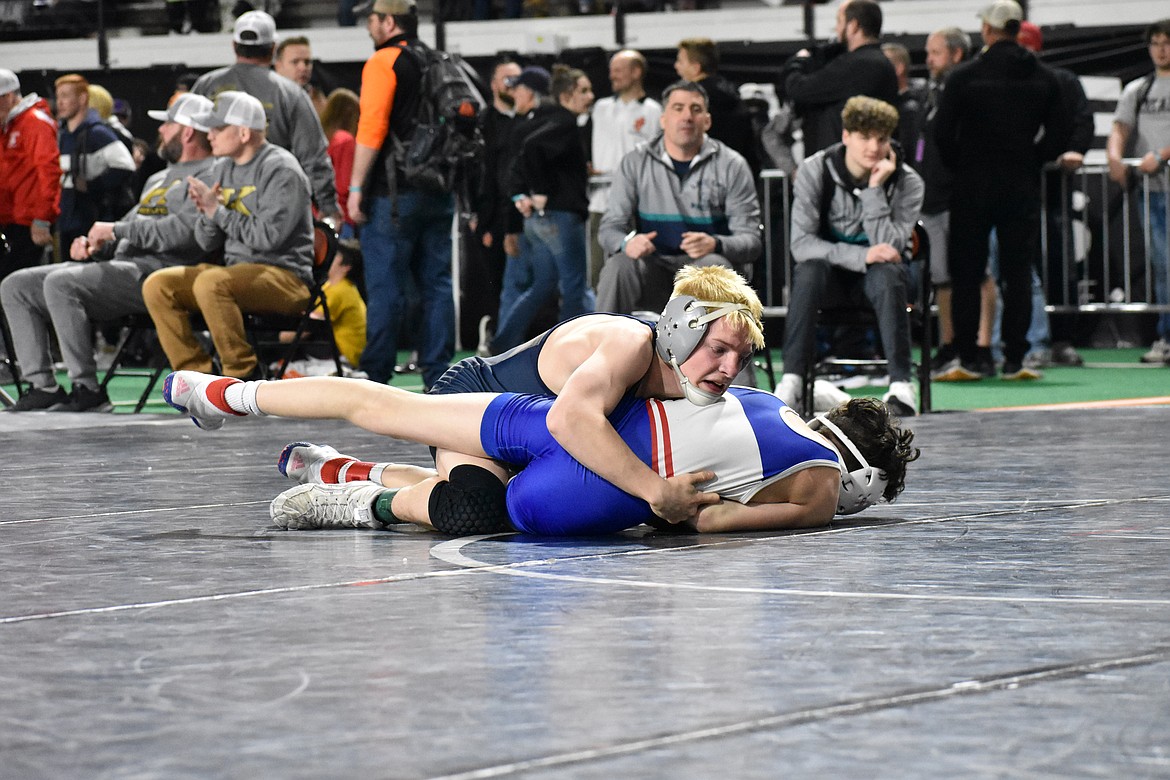 Photo by MOLLY MASON
Zach Macdonald, top, of Lake City, defeated Logan Bradley of Coeur d'Alene 19-2 in the 5A quarterfinals at 106 pounds on Friday to advance to today's semifinals at the state high school wrestling tournaments at Holt Arena in Pocatello.