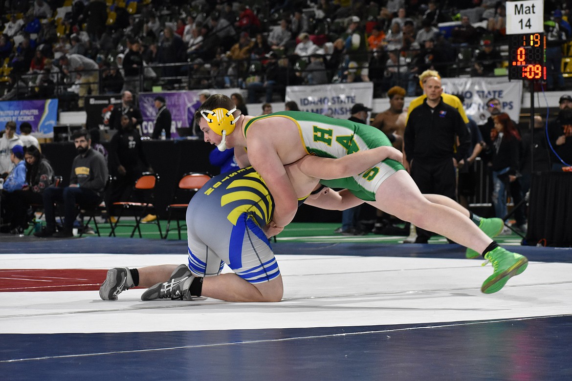 Photo by MOLLY MASON
Preston Jeffs, right, of Lakeland, went on to pin Gentry Geary of Preston in 5:21 in a 4A first-round match at 285 pounds at the state high school wrestling tournaments at Holt Arena in Pocatello. Jeffs then won his quarterfinal match to advance to today's semifinals.