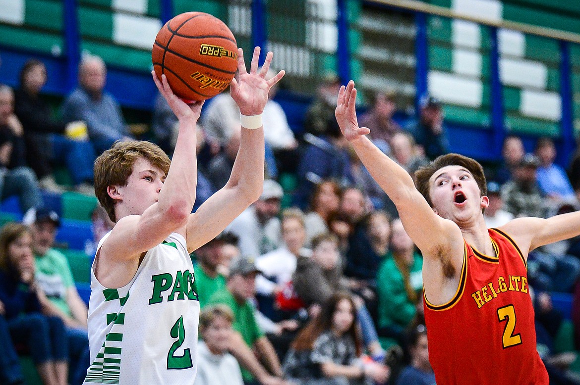 Glacier's Connor Sullivan (2) shoots a three guarded by Missoula Hellgate's Asher Topp (2) at Glacier High School on Saturday, Feb. 26. (Casey Kreider/Daily Inter Lake)