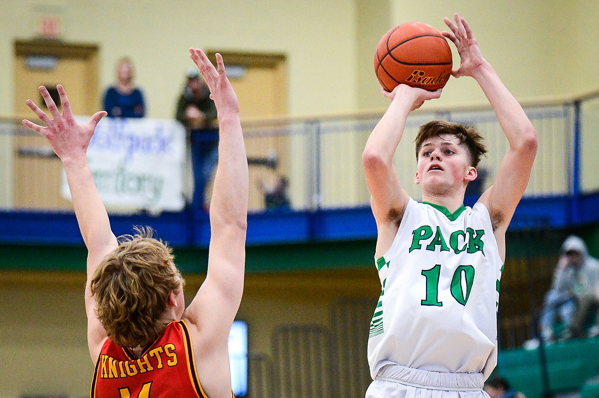 Glacier's Nolan Hyde (10) shoots a three guarded by Missoula Hellgate's Brogan Callaghan (14) at Glacier High School on Saturday, Feb. 26. (Casey Kreider/Daily Inter Lake)