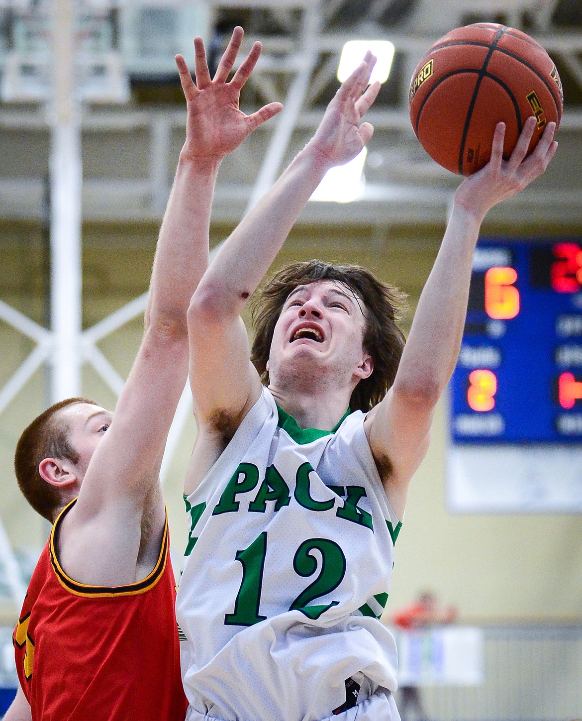 Glacier's Kyson Wagner (12) goes to the basket against Missoula Hellgate's Griffin Kinch (5) at Glacier High School on Saturday, Feb. 26. (Casey Kreider/Daily Inter Lake)