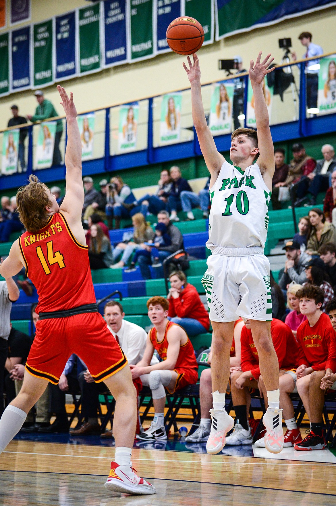 Glacier's Nolan Hyde (10) shoots a three guarded by Missoula Hellgate's Brogan Callaghan (14) at Glacier High School on Saturday, Feb. 26. (Casey Kreider/Daily Inter Lake)