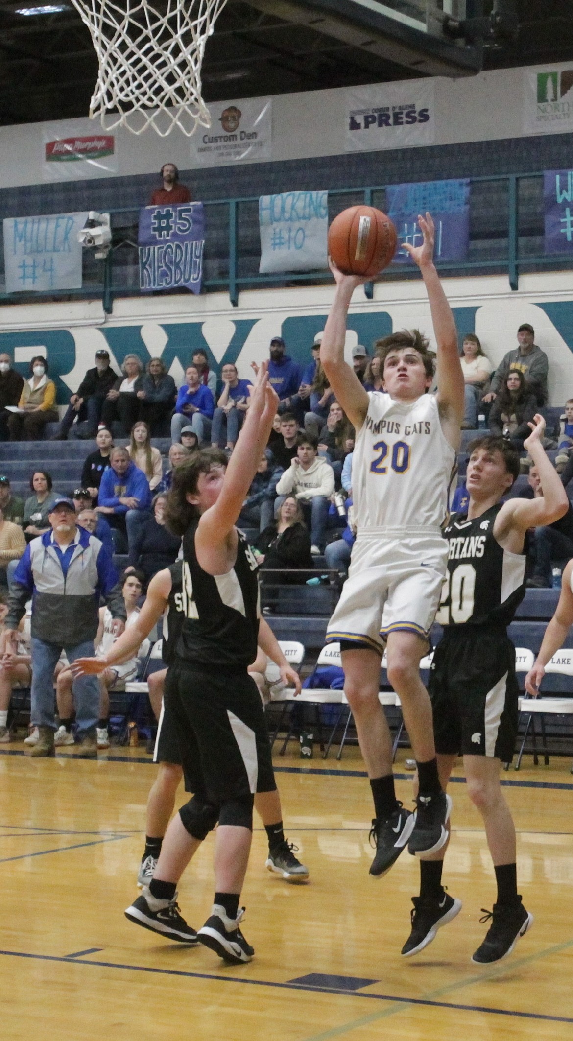 MARK NELKE/Press
Sam Barnett (20) of Clark Fork shoots as Gavin Christopherson, left, and Jude Nelson of Timberline of Weippe defend in a 1A Division II boys basketball state play-in game Saturday at Lake City High.