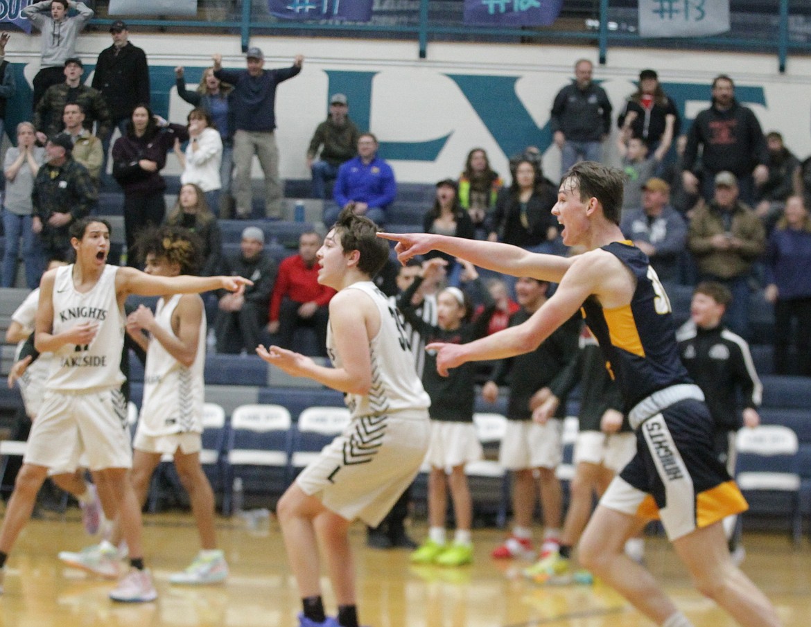 MARK NELKE/Press
Nayati Vassar (11) of Lakeside and Will Casebolt, right, of Logos point in opposite directions in the madness that ensued at the end of the 1A Division I boys basketball state play-in game Saturday at Lake City. Lakeside thought a potential winning shot by Josh Kee, center, beat the buzzer, but officials ruled the ball was still in his hand when the buzzer sounded.