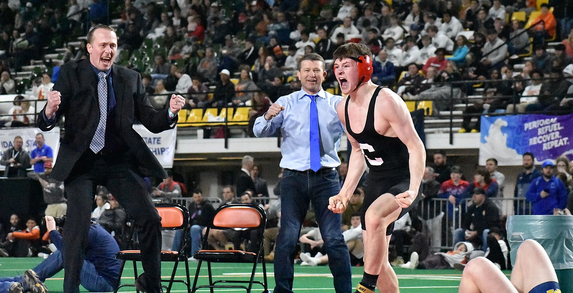 Photo by MOLLY MASON
Porter Craig of Coeur d'Alene celebrates, along with Viking assistant coaches Luke Feist, left, and Pat Craig, after he won the 5A 145-pound state wrestling title Saturday at Holt Arena in Pocatello.