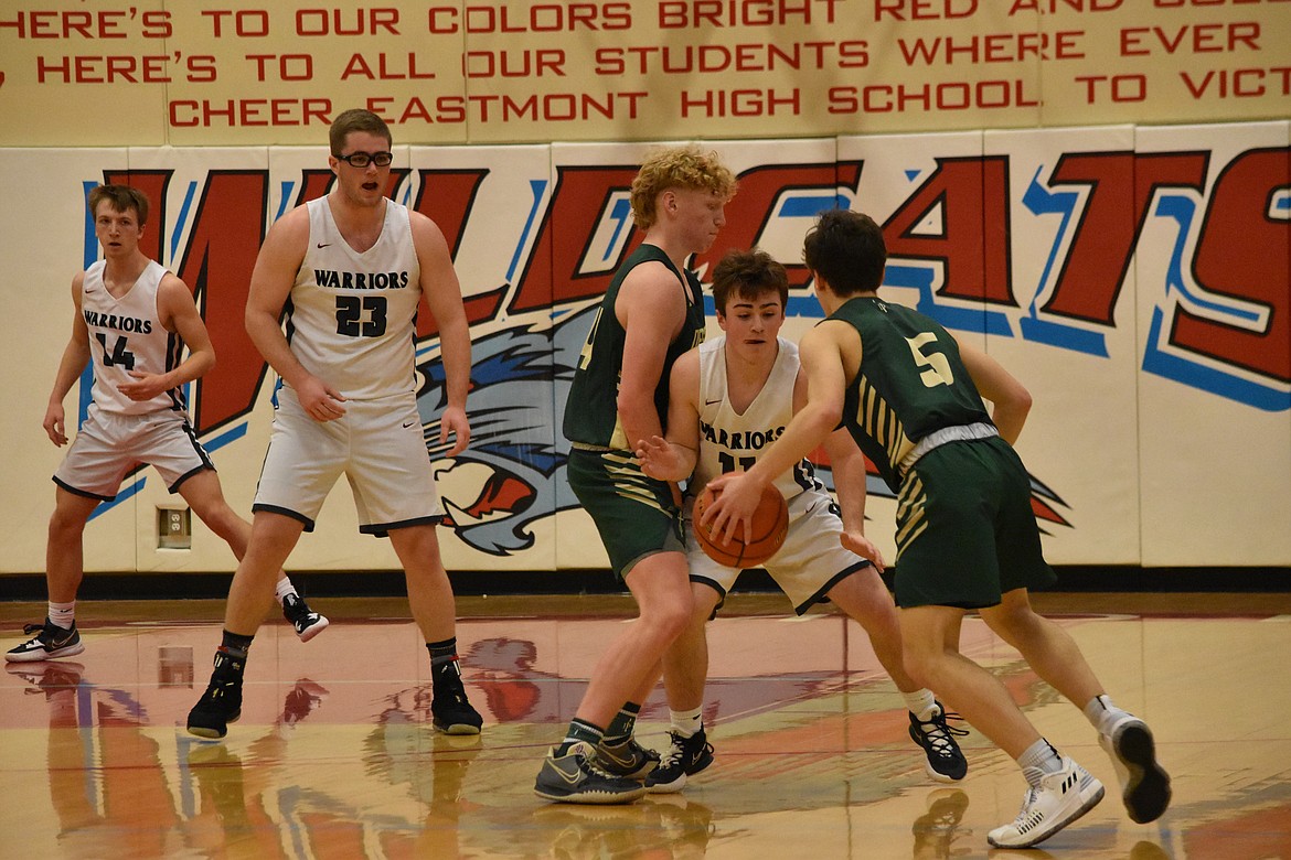 ACH freshman Carter Pitts (11) tries to guard DeSales sophomore Carter Green (5) as another DeSales player blocks him during the regional matchup on Feb. 26.