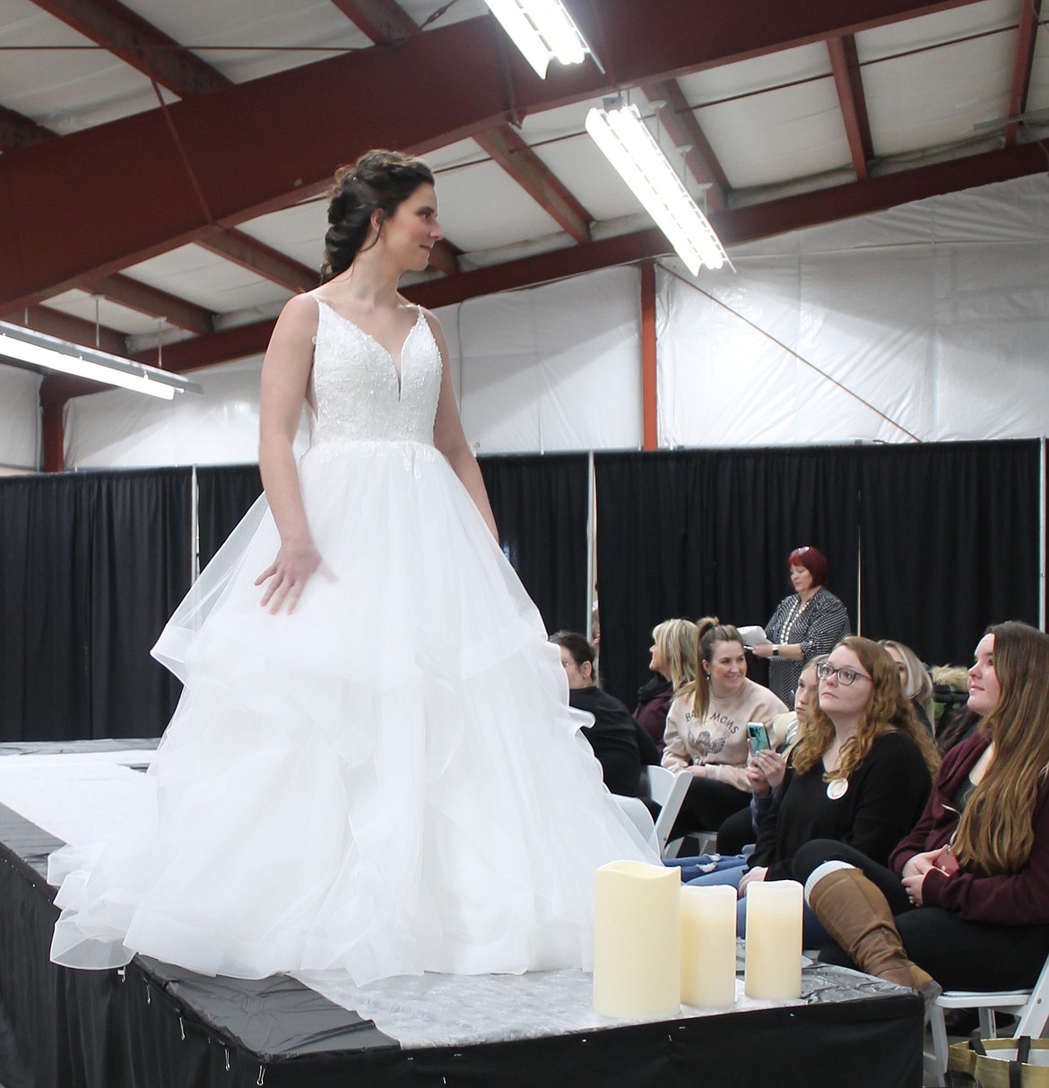 Megan Washburn shows off a Cocomelody bridal gown at the Enchanting Bridal Show Saturday at the Grant County Fairgrounds.