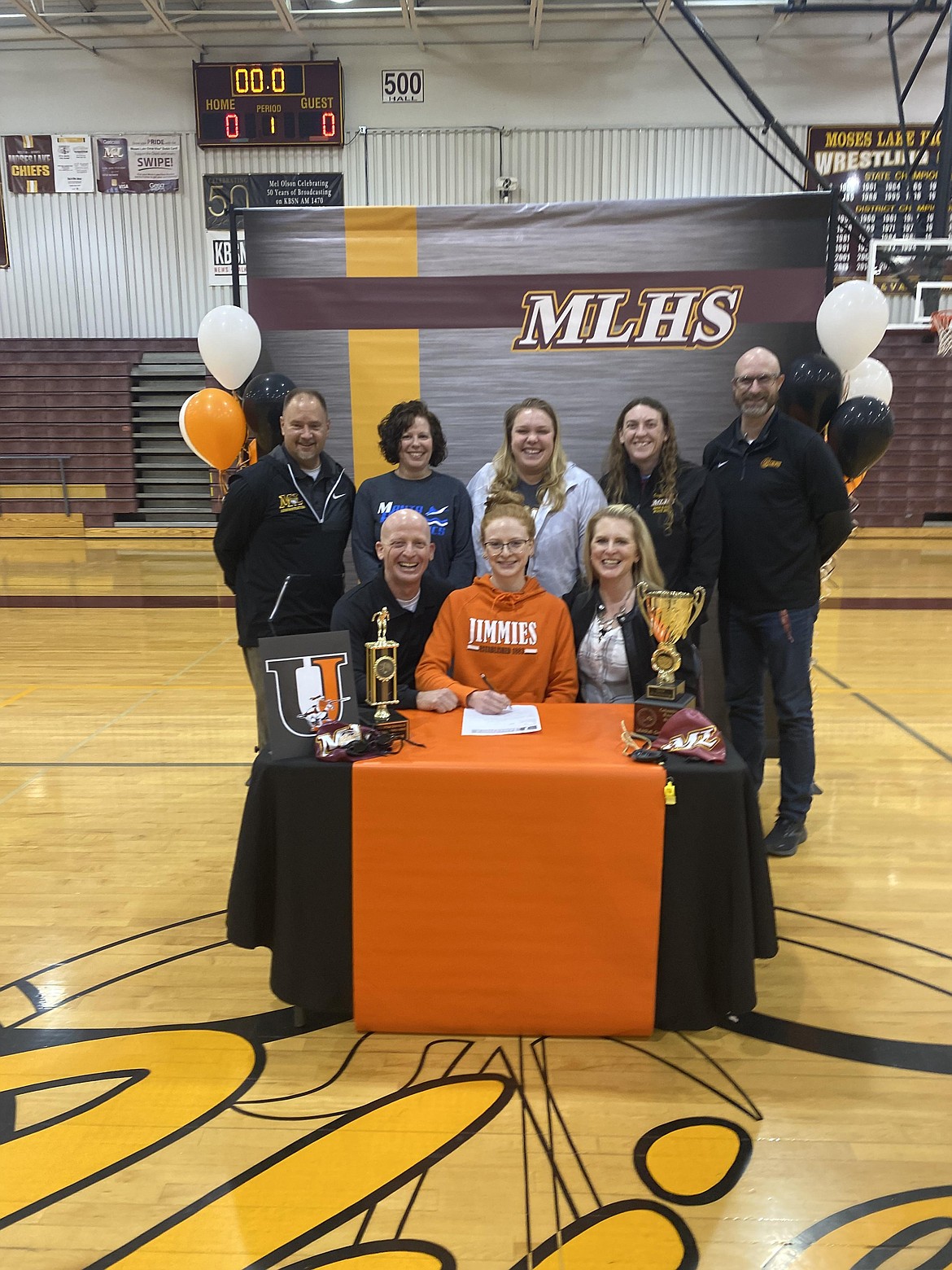 MLHS senior Laurel Knox, bottom row middle, poses with her family, coaches and MLHS athletic staff on Feb. 22 just before signing her offer from the University of Jamestown for swimming.