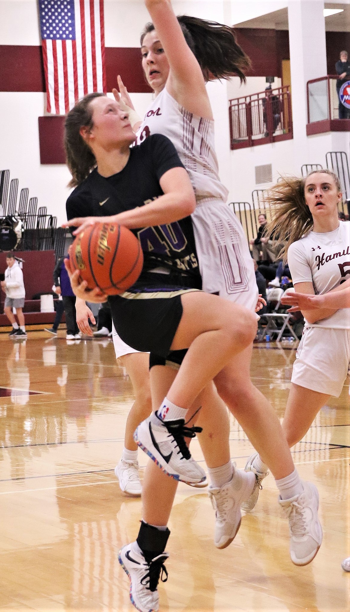 Polson's Mckenna Hanson runs up against a Hamilton defender. (Courtesy of Bob Gunderson)