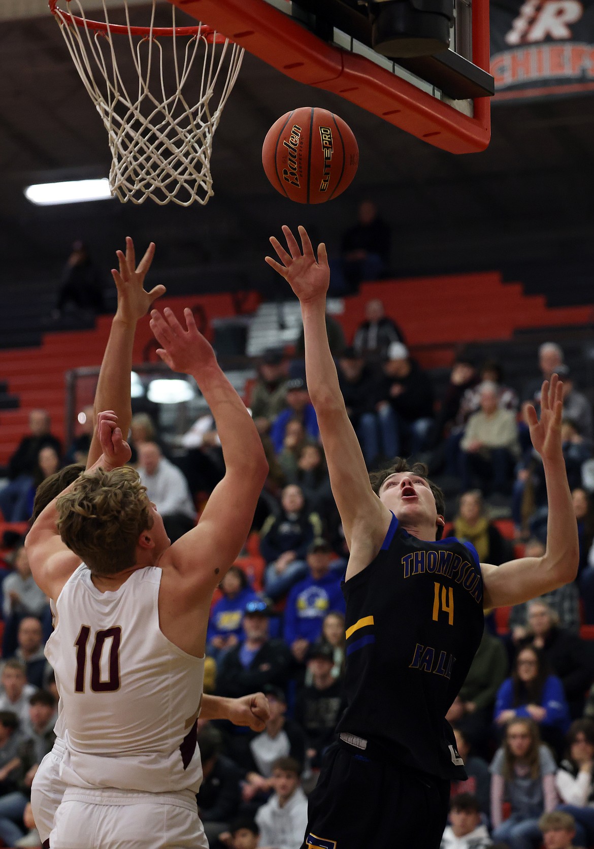 Thompson Falls guard Bryson LeCoure goes up for two over Florence-Carlton's Patrick Duchien during first-round action at the Western B Tournament in Ronan Thursday. (Jeremy Weber/Bigfork Eagle)