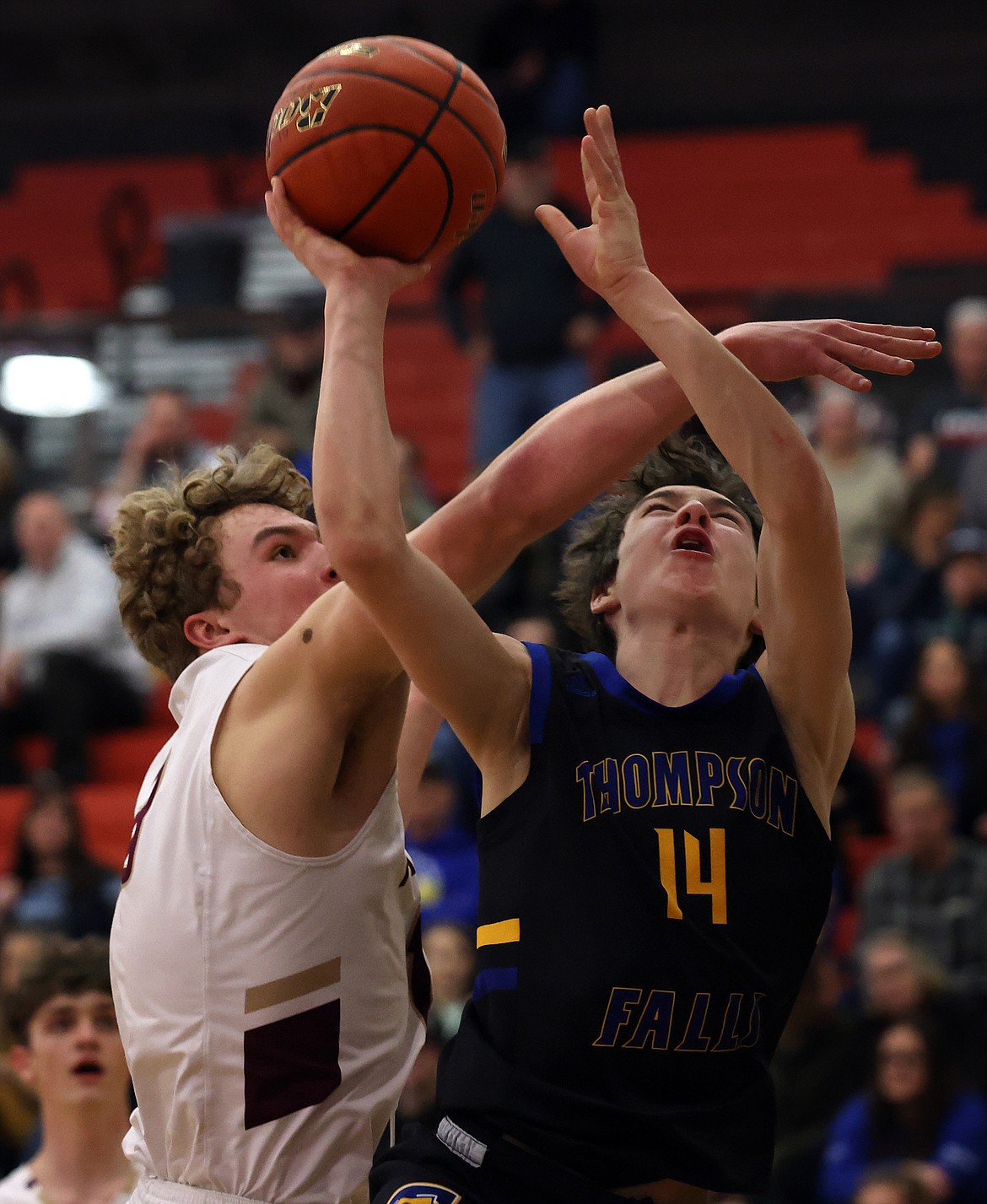 Thompson Falls guard Bryson LeCoure is fouled by Florence-Carlton's Patrick Duchien during first-round action at the Western B Tournament in Ronan Thursday. (Jeremy Weber/Bigfork Eagle)