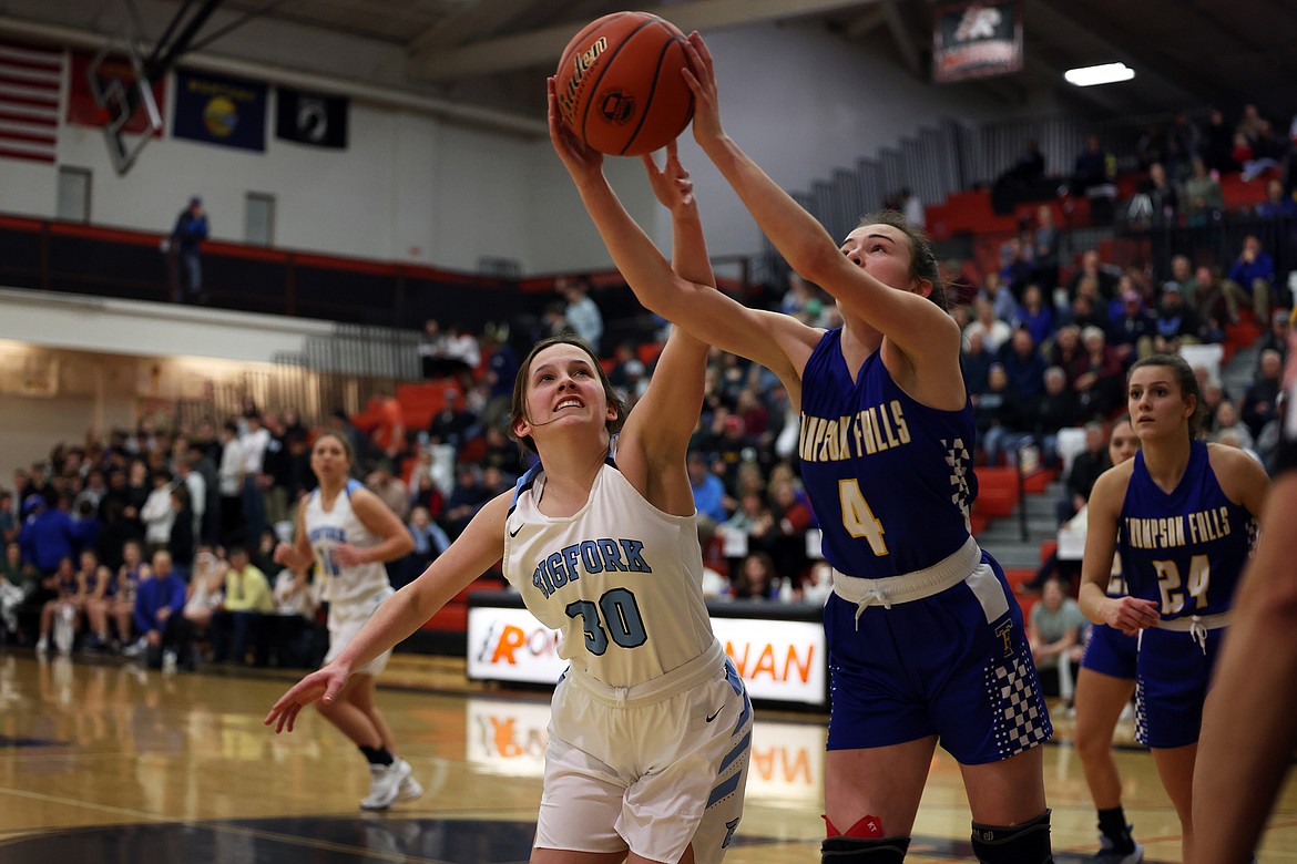 Thompson Falls guard Ellie Baxter battles Bigfork's Callie Martinz for a rebound during the championship game of the Western B Divisional Tournament in Ronan Saturday. (Jeremy Weber/Bigfork Eagle)